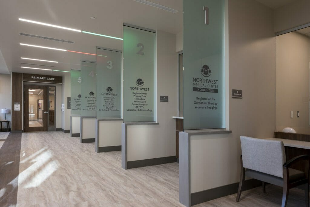 Northwest Medical Center Houghton interior photo showing distinct patient areas marked by number and description on glass wall dividers.