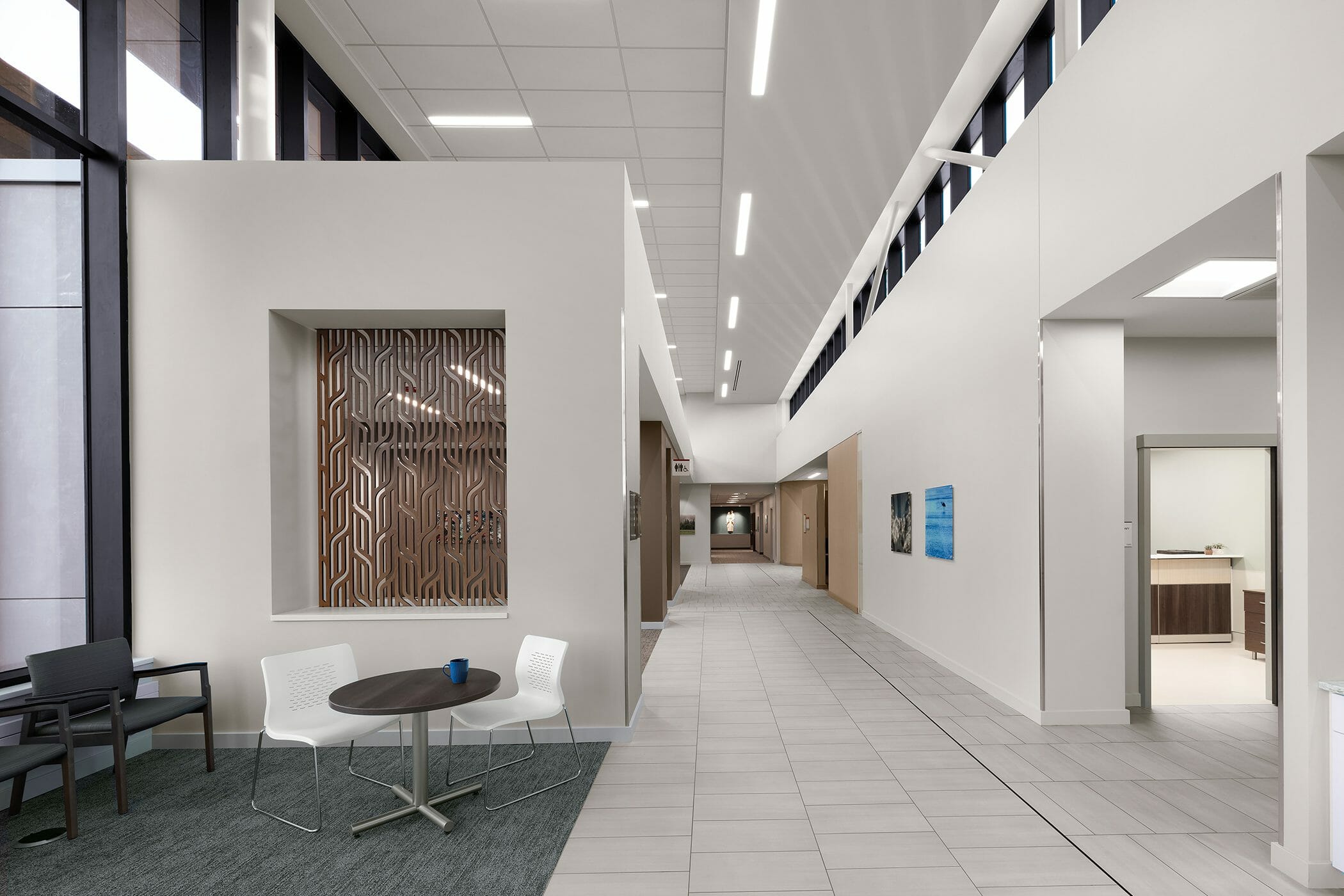 Hallway of CHI Cancer Center with tall white walls and tan wood accents