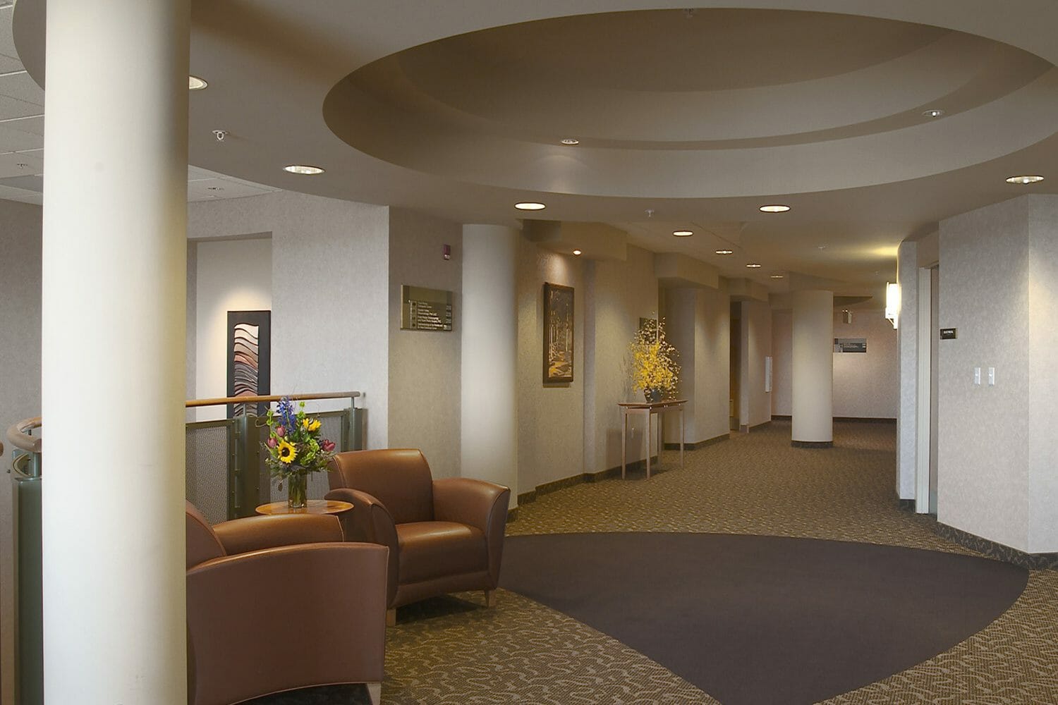upper level open area, leather chairs, hallway to medical offices