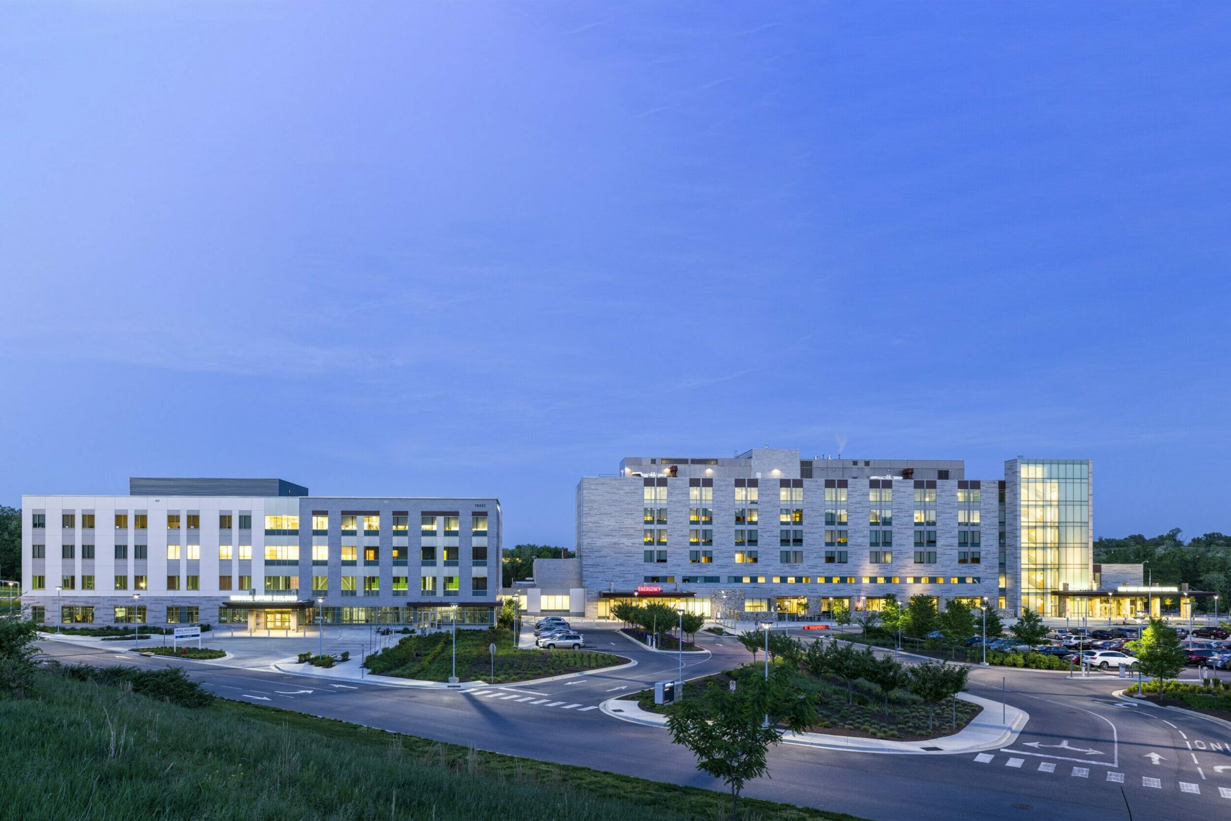 Exterior panoramic view of medical office building connecting to Holy Cross Germantown hospital at dusk