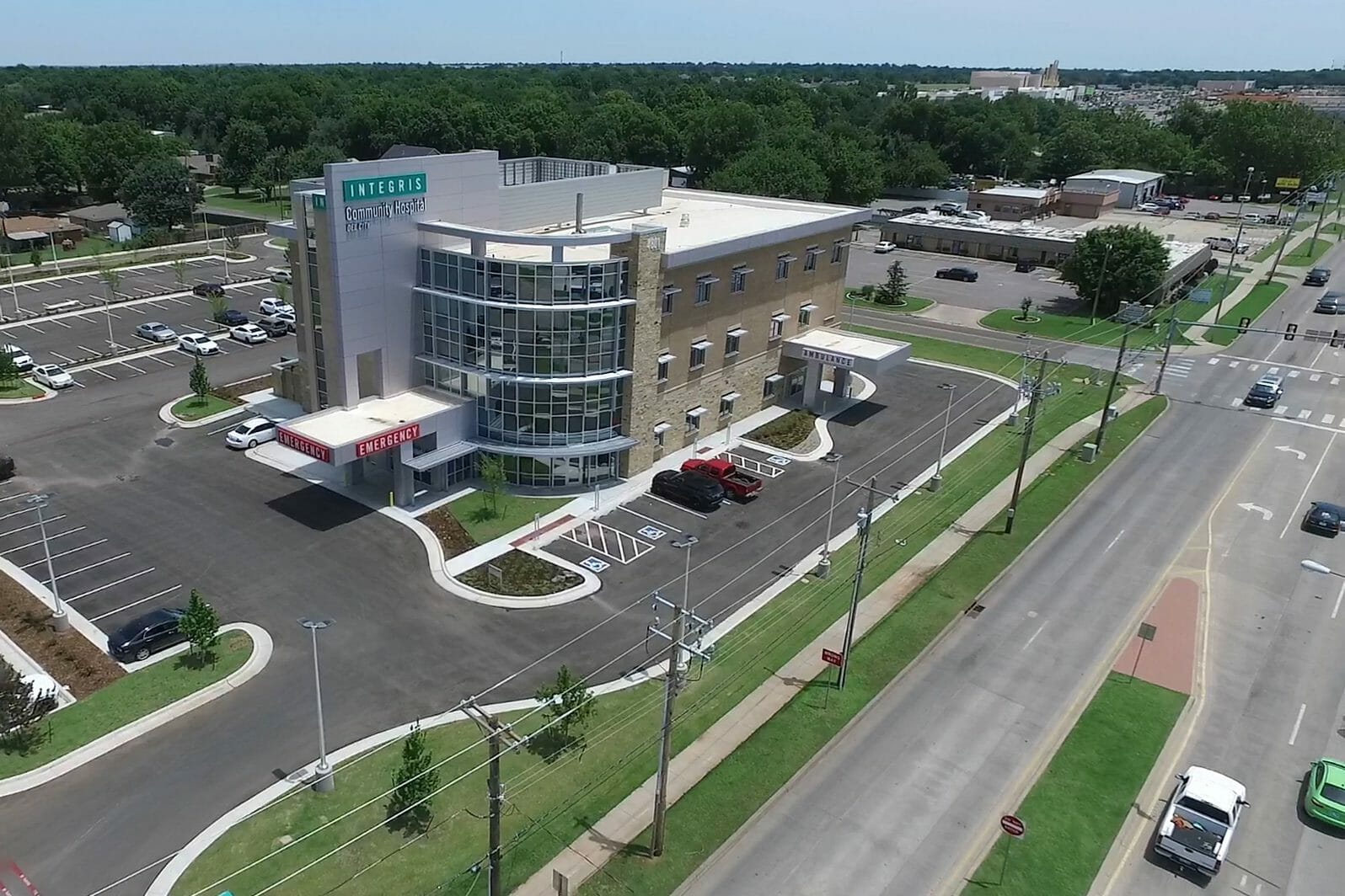 Aerial view of Integris OKC West community hospital with view of the parking lot, nearby main road and residential area behind the hosptial