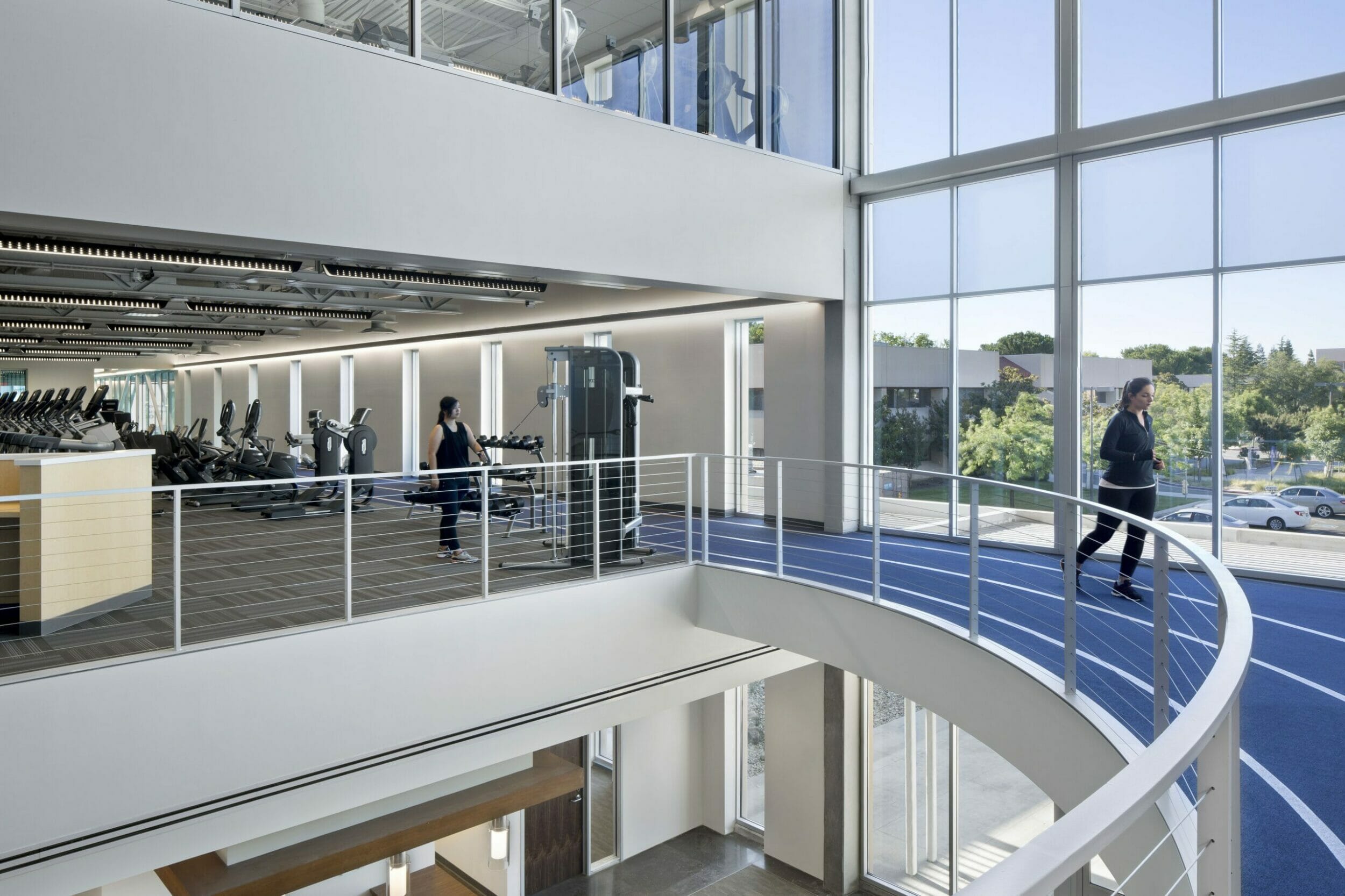 second floor view of a three-story workout center with the second floor running track open to the first floor