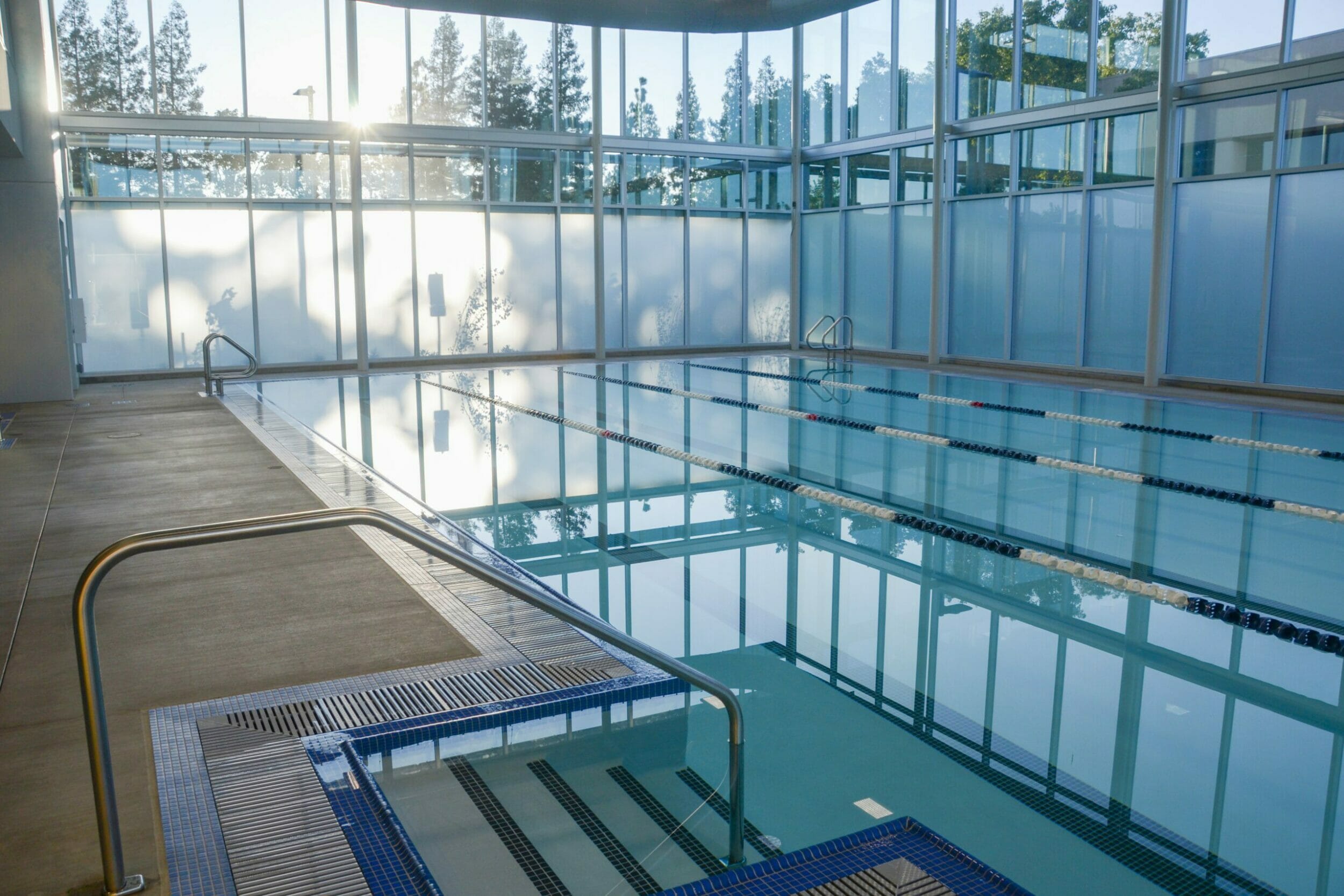 close-up view of water inside lap pool with all glass walls with partial frosted glass