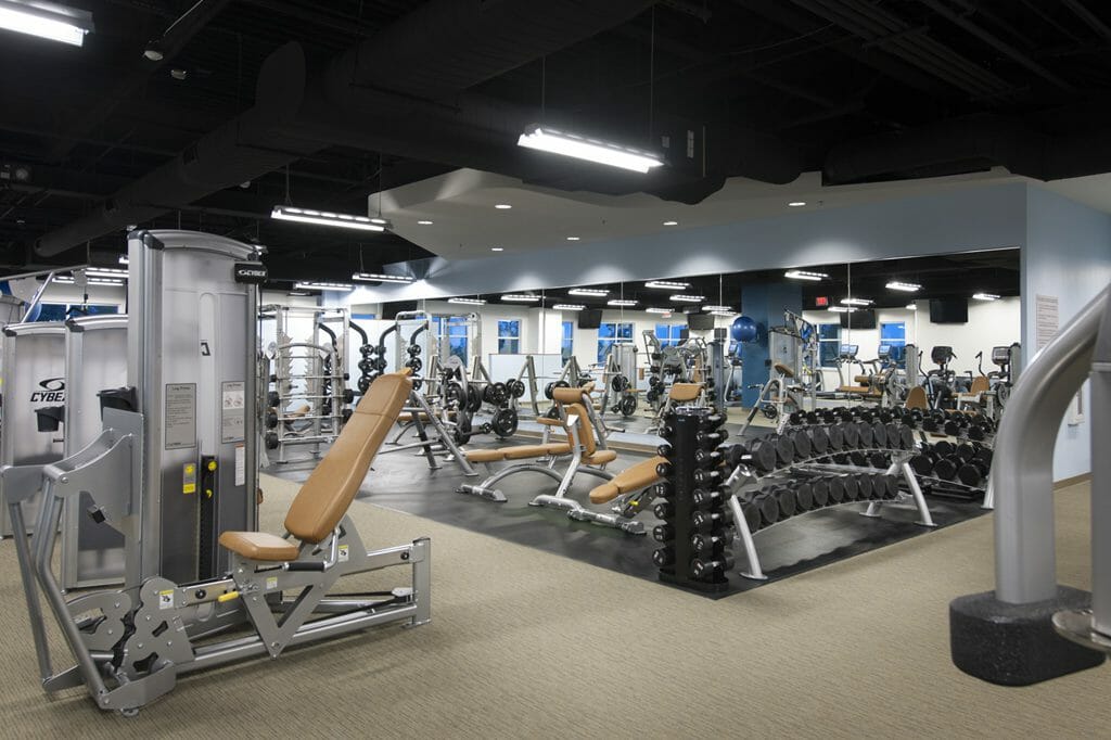Close-up shot of the mirrors and weight lifting area of REX wellness center