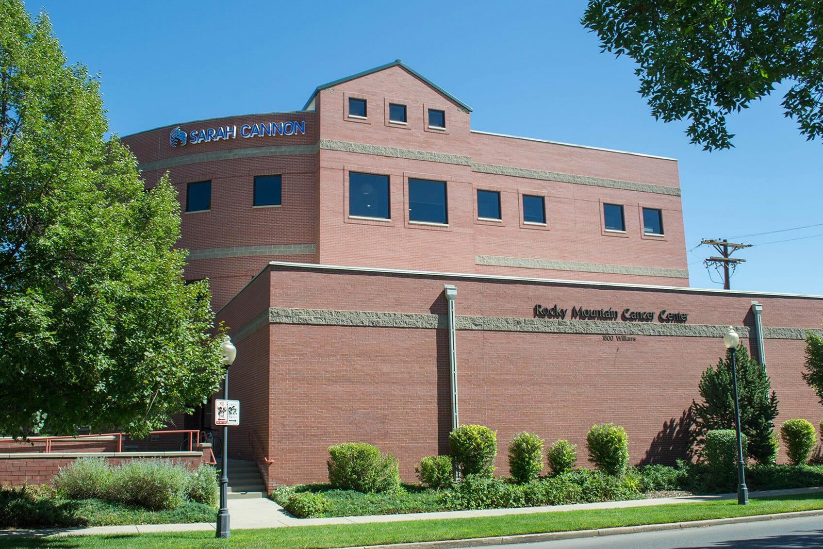 Street view of brick exterior of Rocky Mountain Cancer Center with sarah cannon research institute logo on top of building