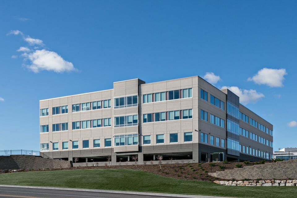 Exterior view of three-story Saint Alphonsus Medical Center - Nampa Hospital with gray and cream exterior finishes