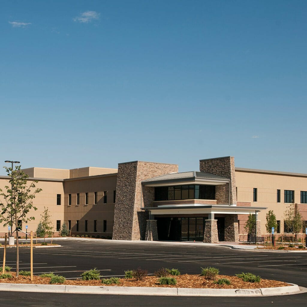 Exterior view of Centura Health st anthony north hospital with tan exterior and stone and brick accents