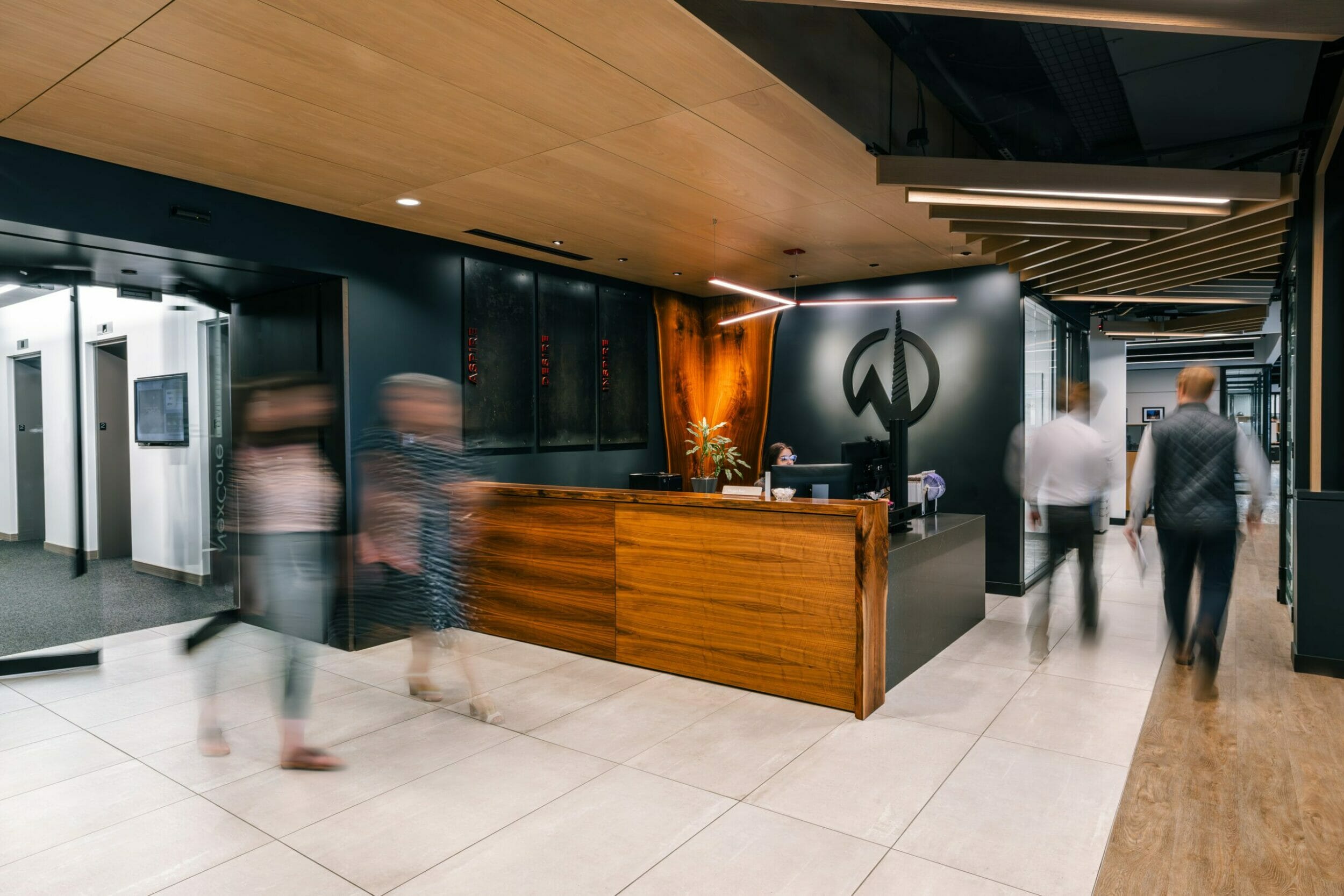 NexCore Group Lobby with receptionist desk and individuals walking through the space
